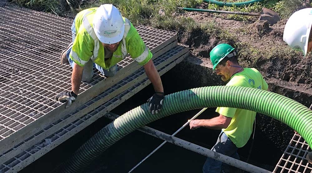 Cleaning Debris from Stormwater Detention Pond Structure